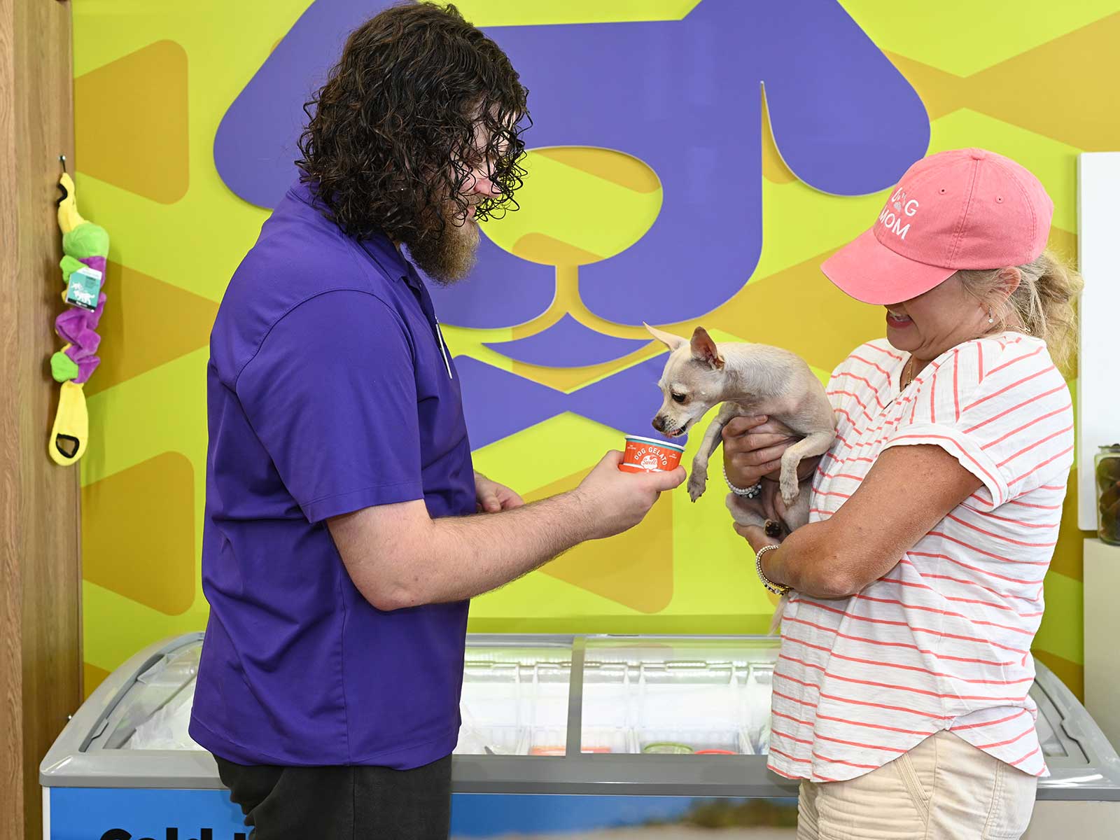 A DOGPerfect team member helping a customer and their dog