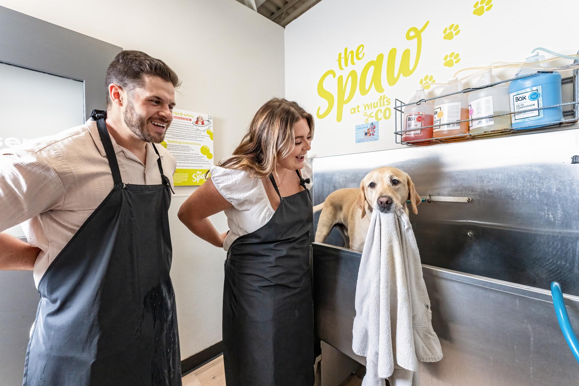 A dog and its people at the Mutts & Co. self-serve dog wash
